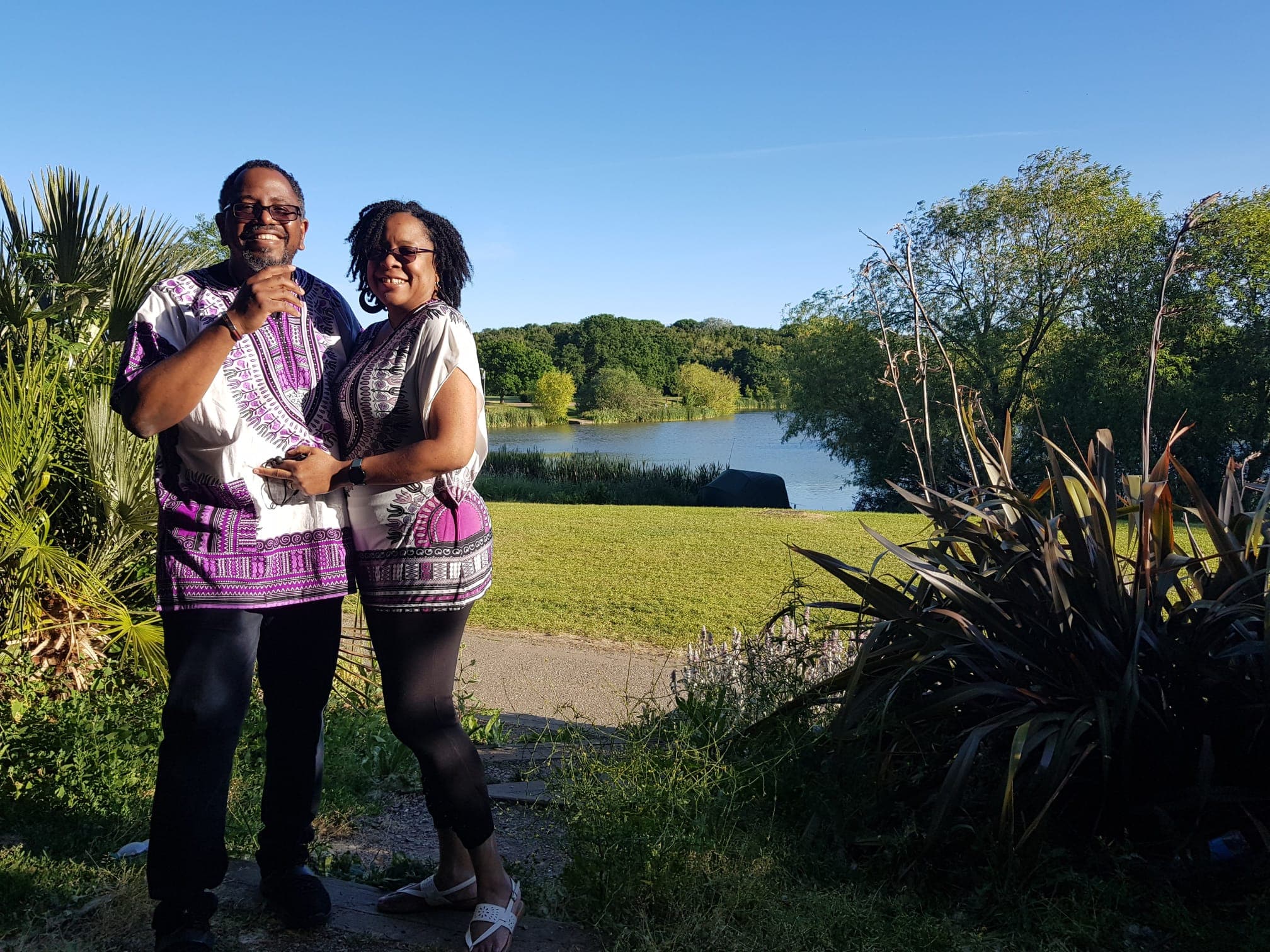 A married couple together beside a lake